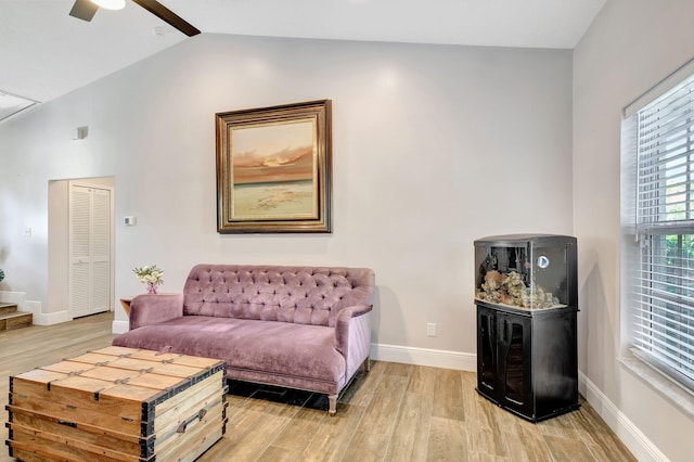 living room with ceiling fan, hardwood / wood-style floors, and lofted ceiling