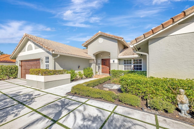 mediterranean / spanish-style home featuring a garage