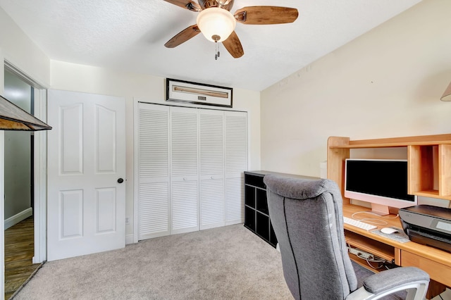 office area featuring ceiling fan and light colored carpet