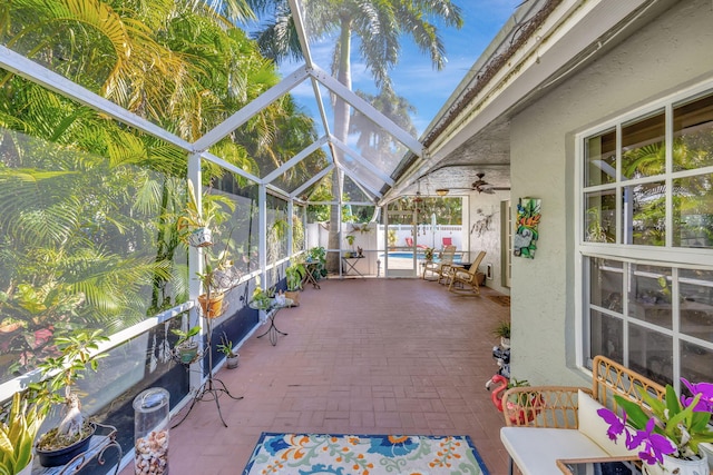 unfurnished sunroom with ceiling fan