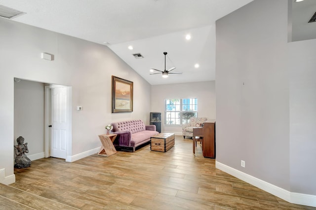 sitting room featuring ceiling fan, high vaulted ceiling, and light hardwood / wood-style floors