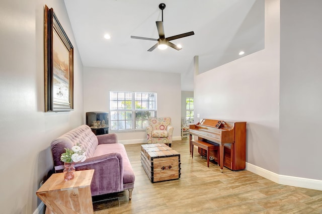 living room featuring ceiling fan and light wood-type flooring