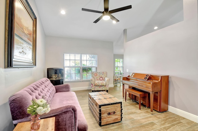 living room featuring light hardwood / wood-style flooring and ceiling fan