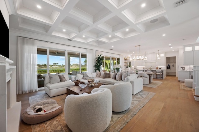 living room with beamed ceiling, a premium fireplace, coffered ceiling, and light hardwood / wood-style flooring