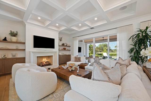 living room with coffered ceiling, light hardwood / wood-style flooring, and beamed ceiling