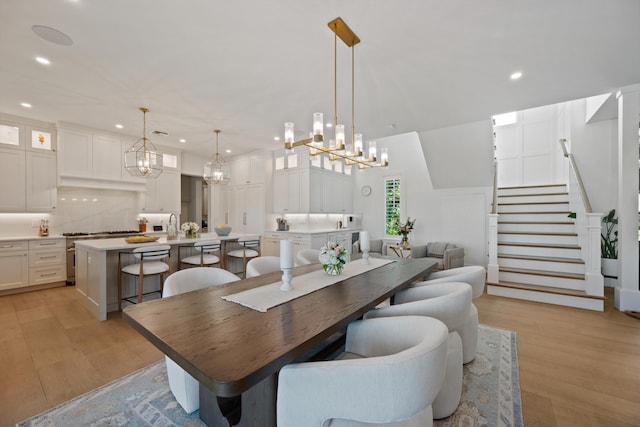 dining space with sink and light hardwood / wood-style floors