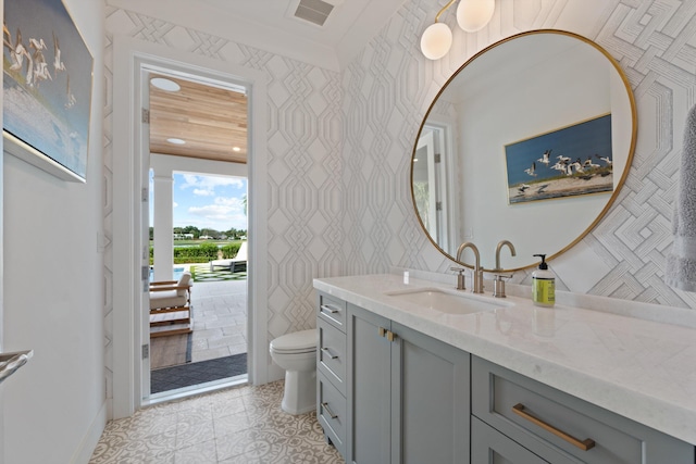 bathroom with vanity, tile patterned flooring, and toilet