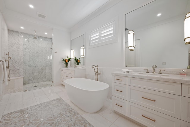 bathroom with crown molding, vanity, and separate shower and tub