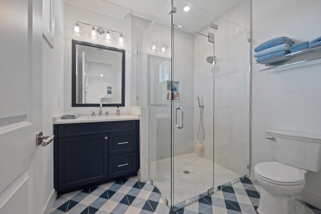 bathroom with walk in shower, tile patterned floors, toilet, and vanity