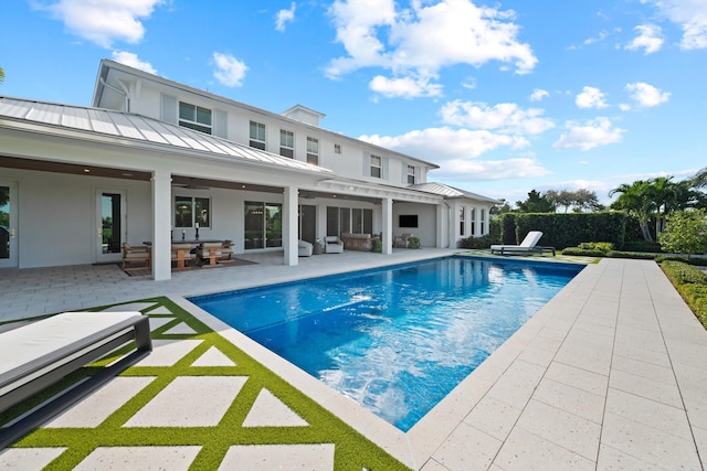 view of swimming pool with an outdoor living space, a patio area, and ceiling fan