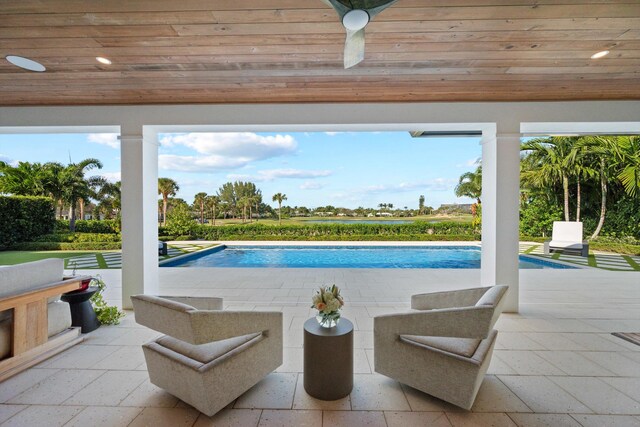 view of swimming pool with a patio area and ceiling fan