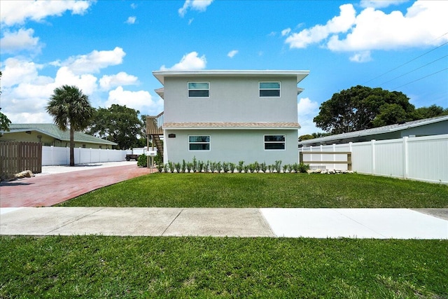 back of house featuring a lawn