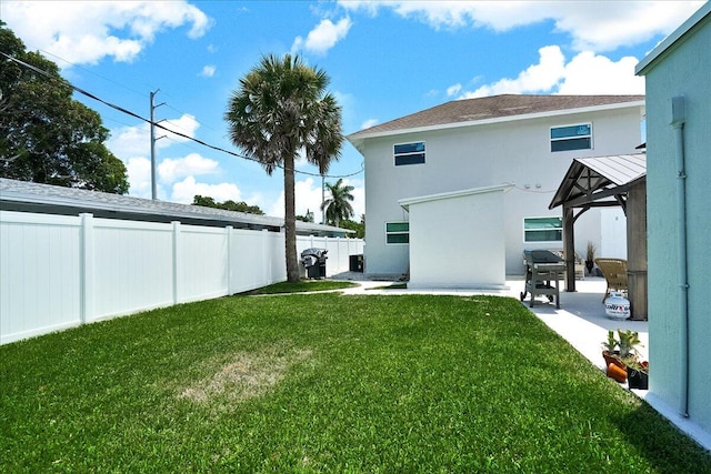 rear view of house with a lawn and a patio