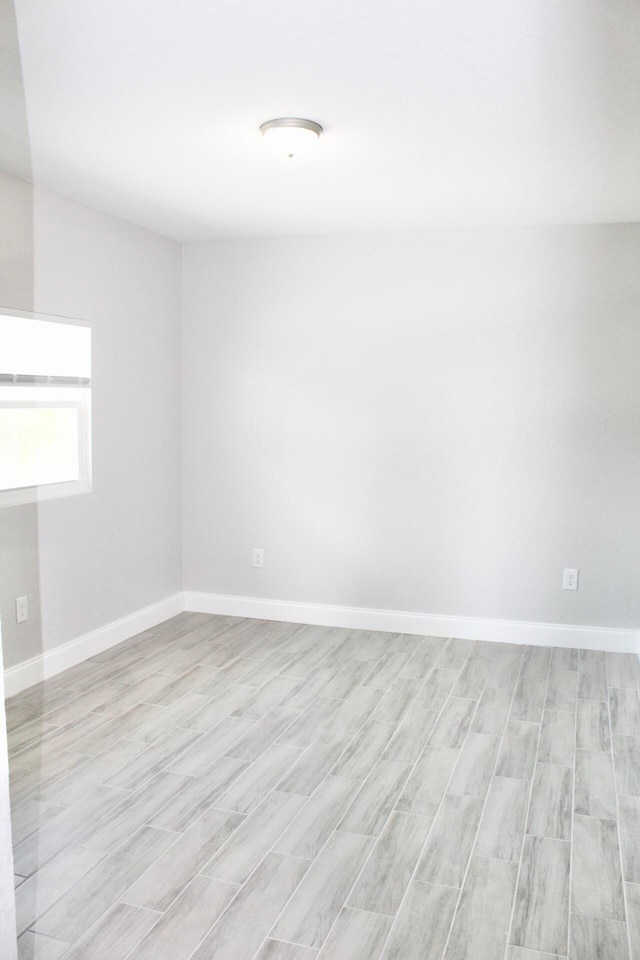 empty room with light hardwood / wood-style flooring