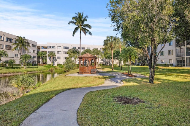 view of home's community with a gazebo, a lawn, and a water view