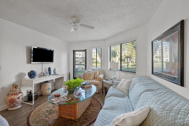 living room with hardwood / wood-style floors, ceiling fan, and a textured ceiling