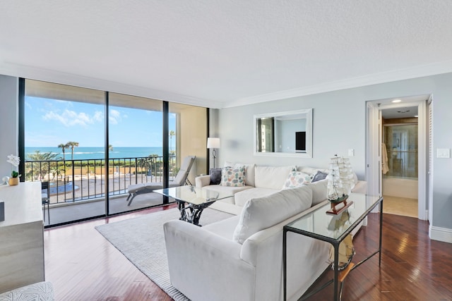 living room featuring wood-type flooring, a water view, and ornamental molding