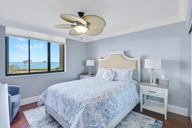 bedroom featuring a water view, ceiling fan, ornamental molding, and dark hardwood / wood-style floors