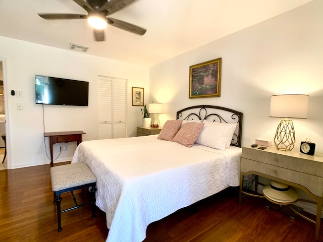 bedroom featuring ceiling fan, dark wood-type flooring, and a closet