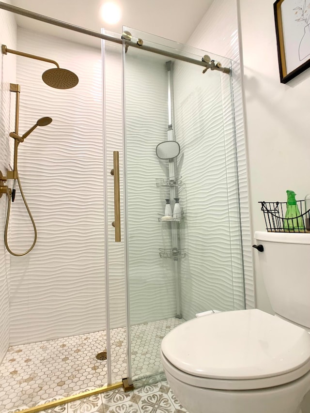 bathroom featuring an enclosed shower and toilet