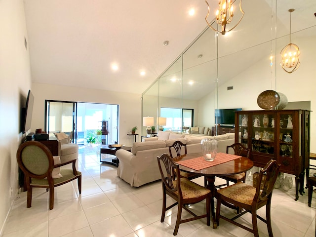 dining area with high vaulted ceiling, a notable chandelier, and light tile patterned flooring