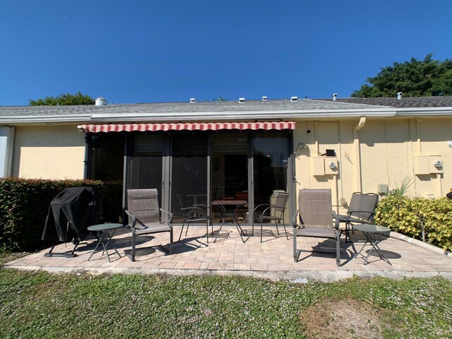 back of property with a patio