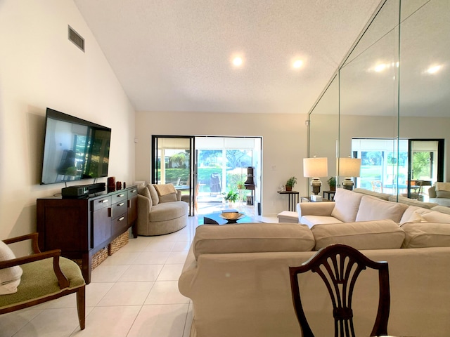 living room featuring light tile patterned floors, a textured ceiling, and high vaulted ceiling