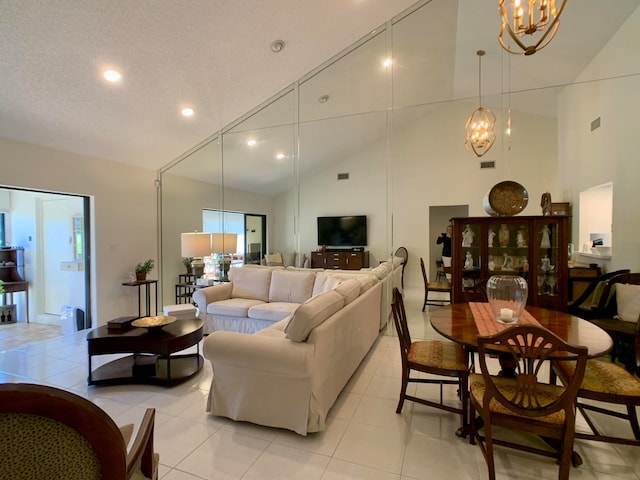 tiled living room with a notable chandelier, a textured ceiling, and high vaulted ceiling