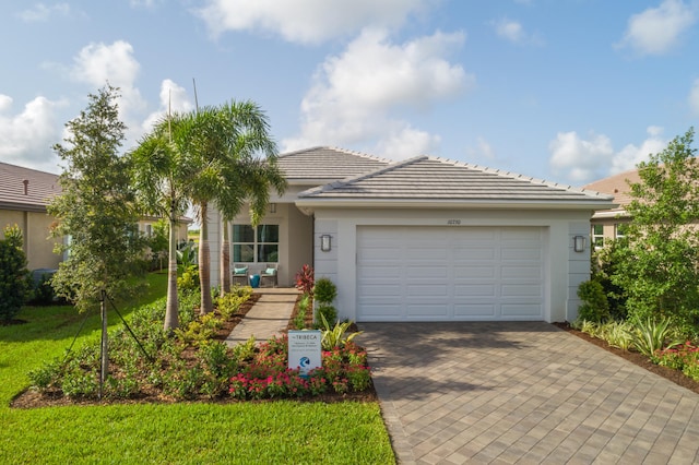 single story home featuring a front lawn and a garage