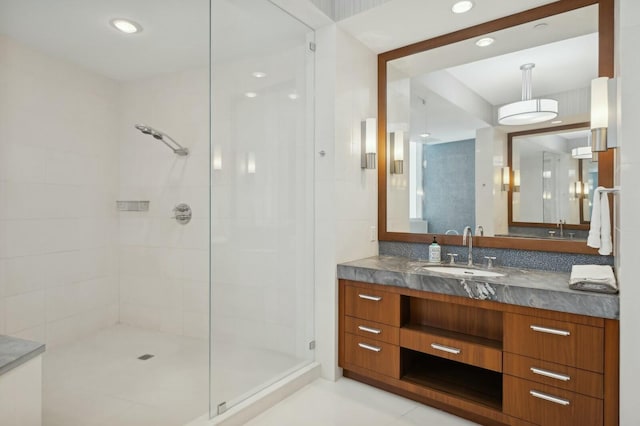 bathroom featuring vanity and a shower with shower door