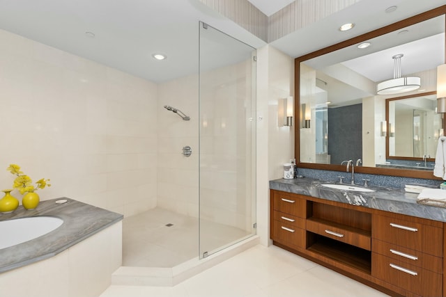 bathroom with tile patterned floors, vanity, and a shower with shower door