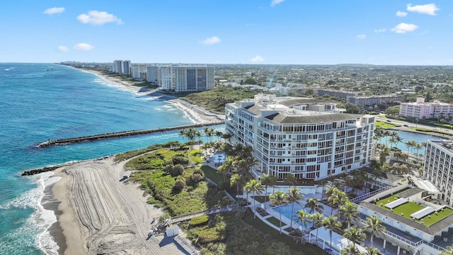 drone / aerial view featuring a water view and a view of the beach