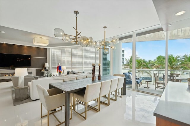 dining area featuring a wall of windows and an inviting chandelier