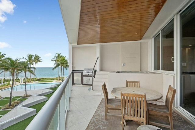 balcony with a grill and a water view