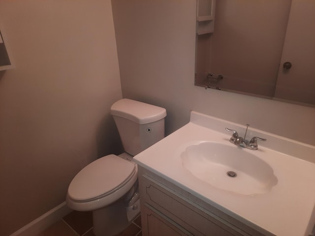 bathroom with tile patterned floors, vanity, and toilet