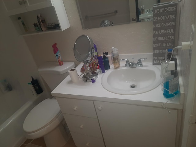 bathroom featuring vanity and toilet