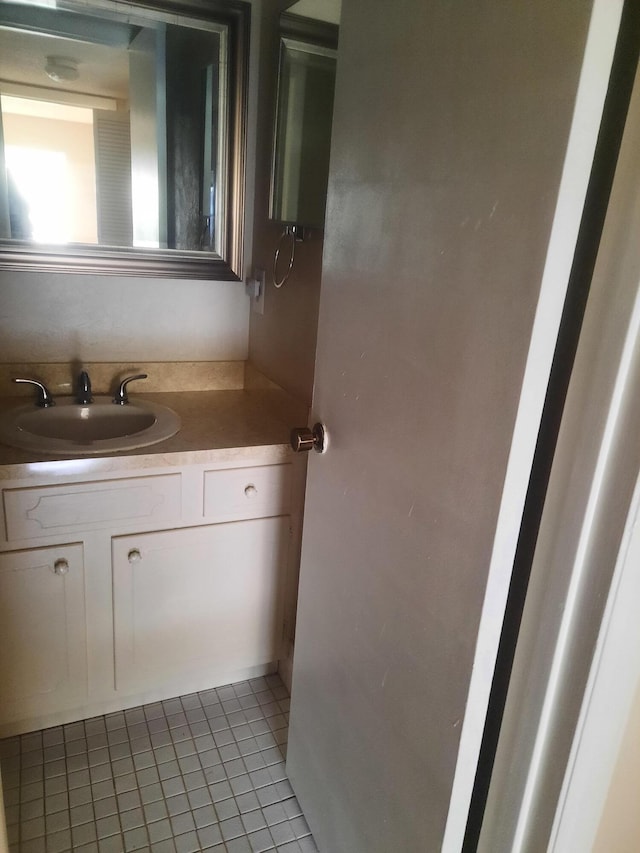 bathroom featuring tile patterned flooring and vanity