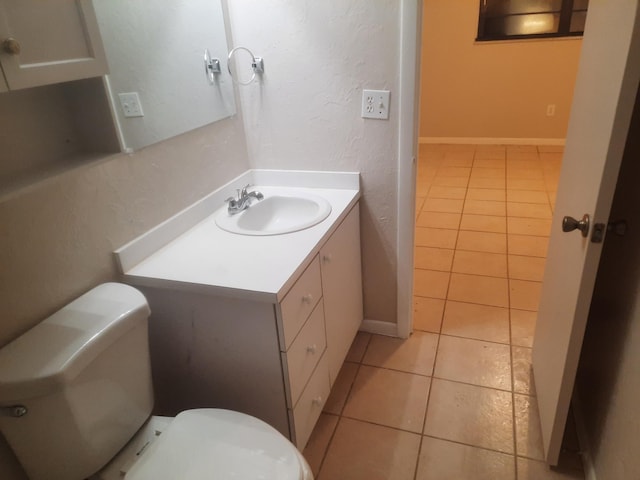 bathroom featuring tile patterned floors, vanity, and toilet