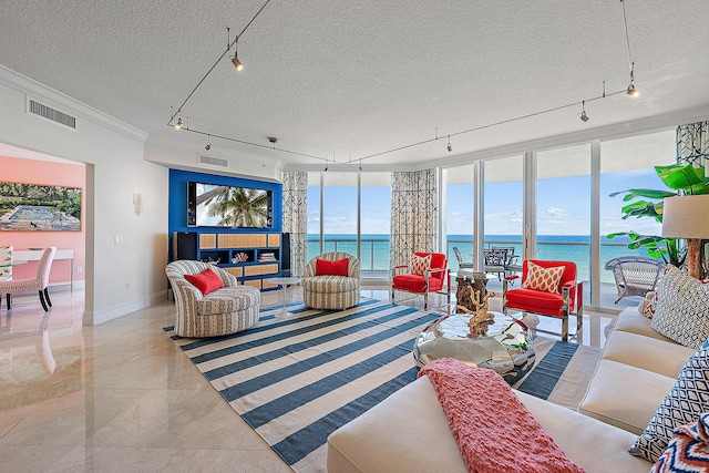 living room featuring visible vents, a textured ceiling, and baseboards