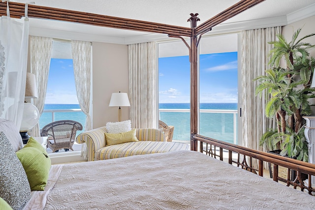 bedroom featuring a water view, access to outside, and crown molding