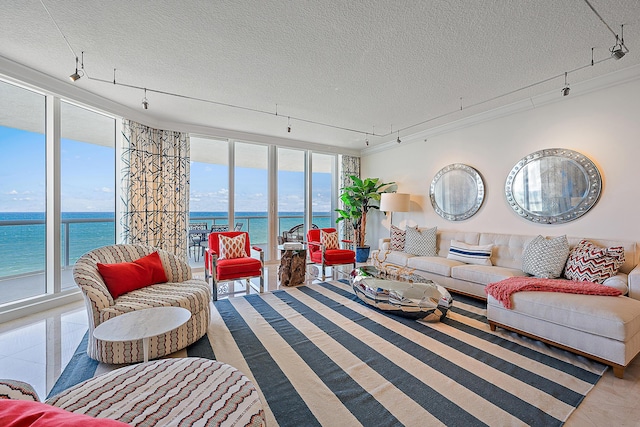 tiled living area featuring a textured ceiling, a water view, and rail lighting