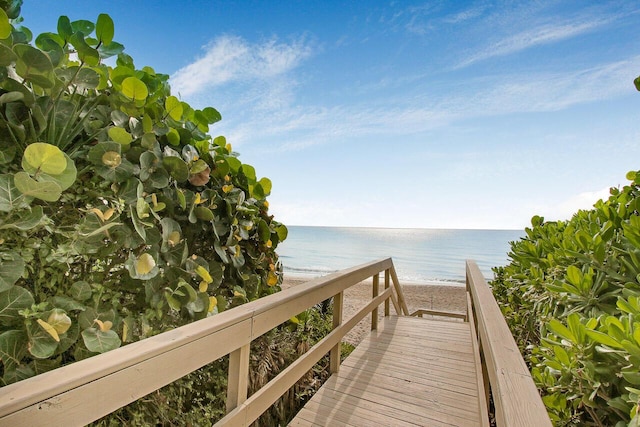 surrounding community with a beach view and a water view