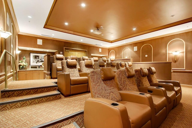 home theater with visible vents, a raised ceiling, ornamental molding, carpet flooring, and recessed lighting