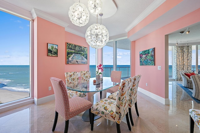 dining area with a chandelier, crown molding, baseboards, and floor to ceiling windows