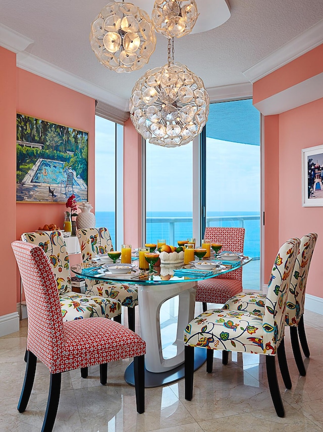 dining area featuring baseboards, a textured ceiling, plenty of natural light, and crown molding