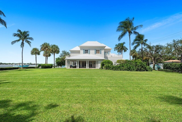 view of front of house featuring a balcony and a front yard