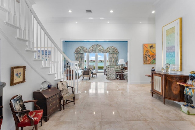 foyer entrance featuring french doors and ornamental molding