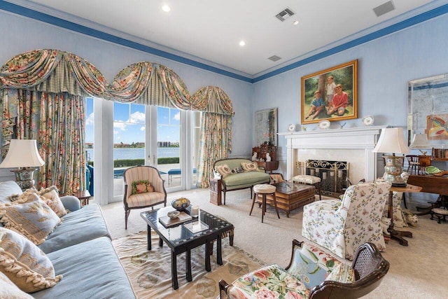 living room with a water view, ornamental molding, and light carpet