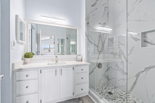 bathroom with vanity, wood-type flooring, and a shower with door