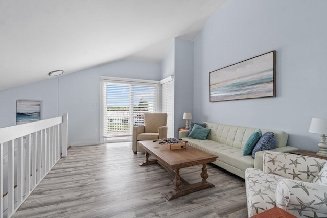 living room featuring light hardwood / wood-style floors and lofted ceiling